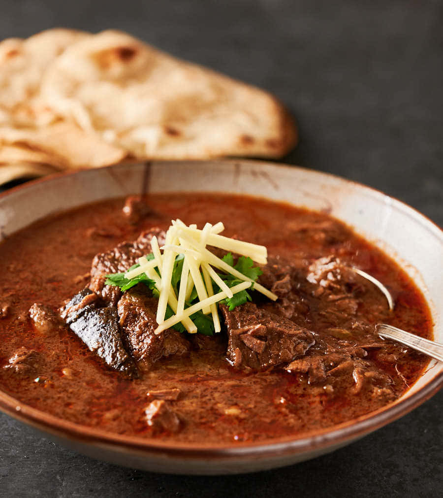 Caption: Delightful Bowl Of Nihari - A Feast For The Eyes And Palate Wallpaper