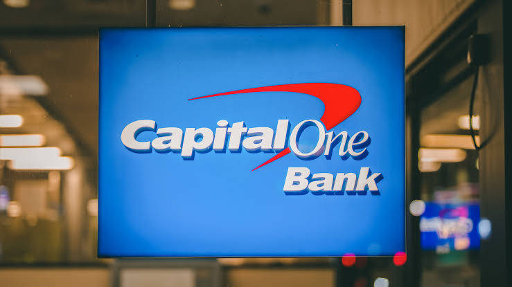 Caption: Diverse Capital One Team Brainstorming Wallpaper