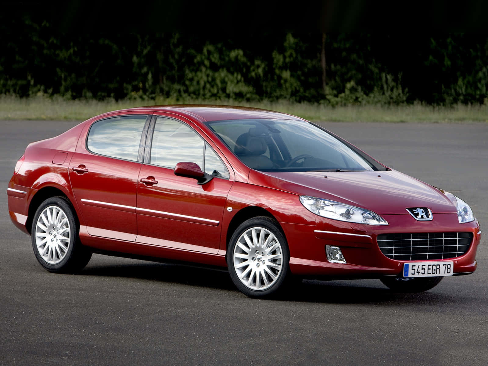 Caption: Elegant Peugeot 407 Gleaming Under The Sunlight Wallpaper