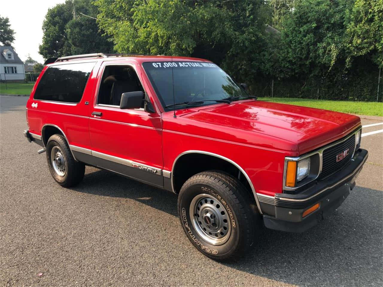 Caption: Gmc Jimmy Off-roading Through Pristine Wilderness Wallpaper