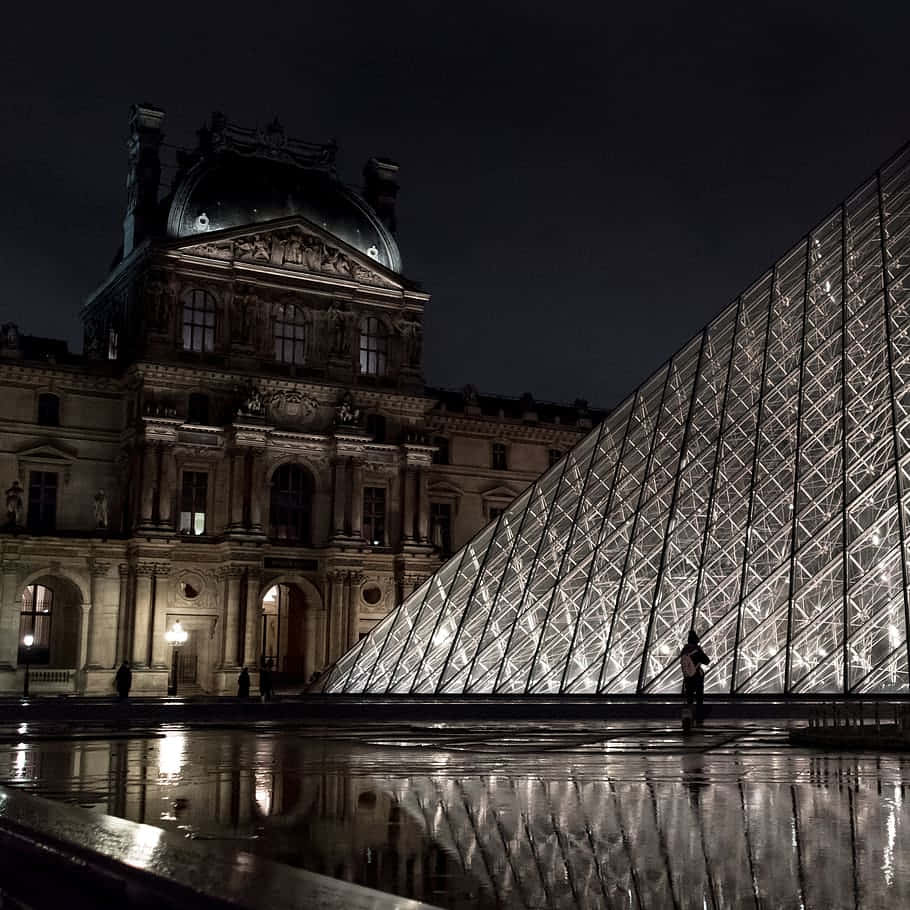 Caption: Illuminated Louvre Museum At Night Wallpaper