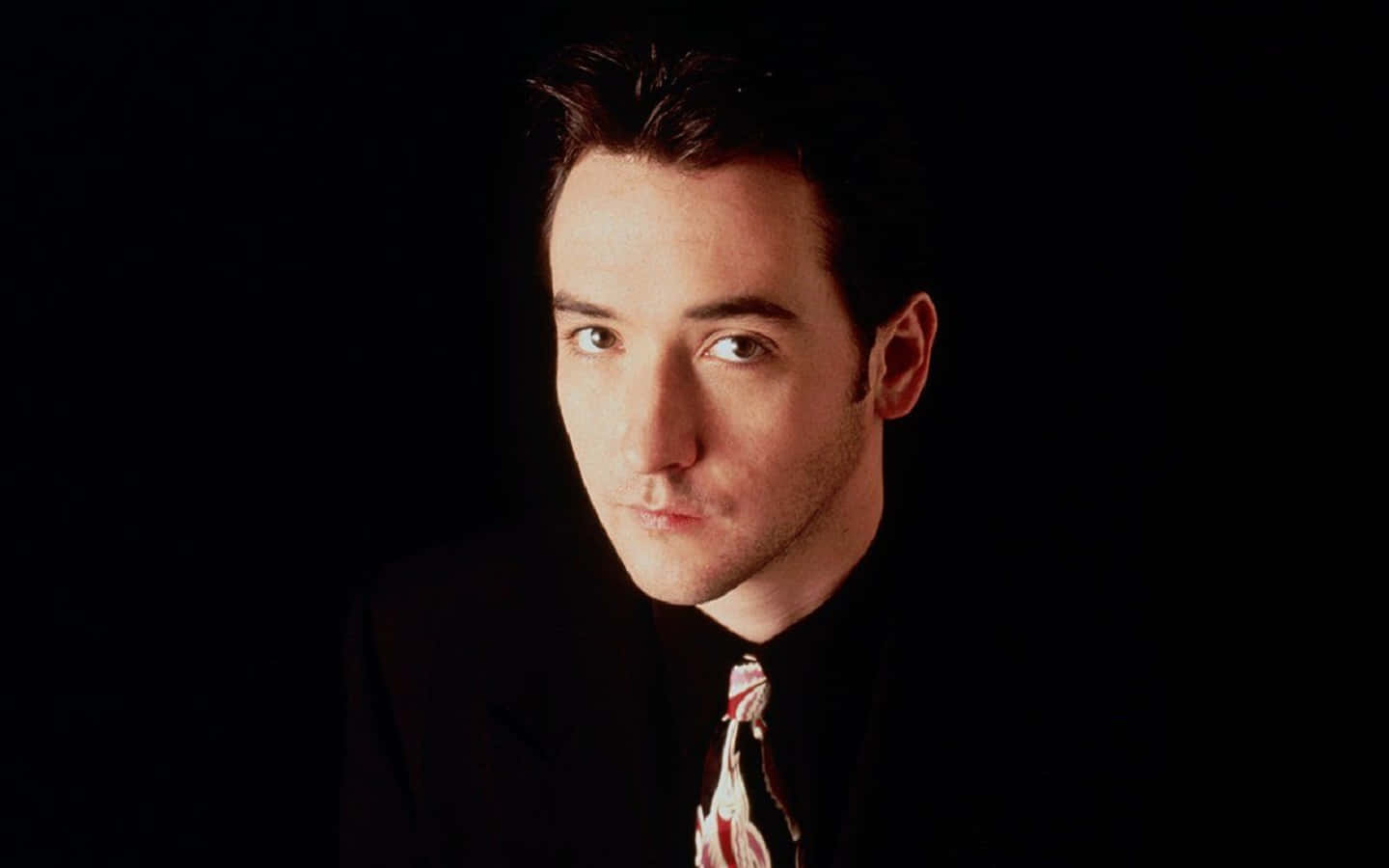 Caption: John Cusack In A Reflective Pose Wallpaper