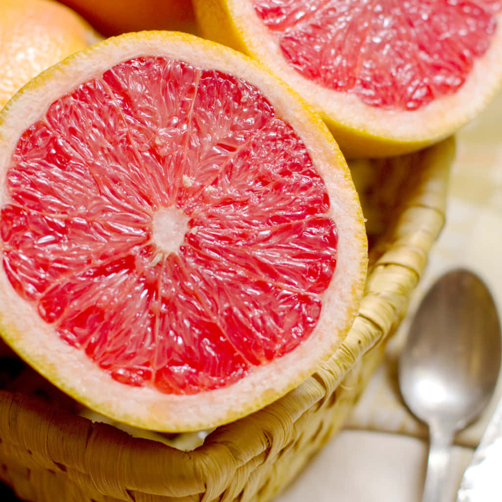 Caption: Juicy Pink Grapefruit Wedges Wallpaper