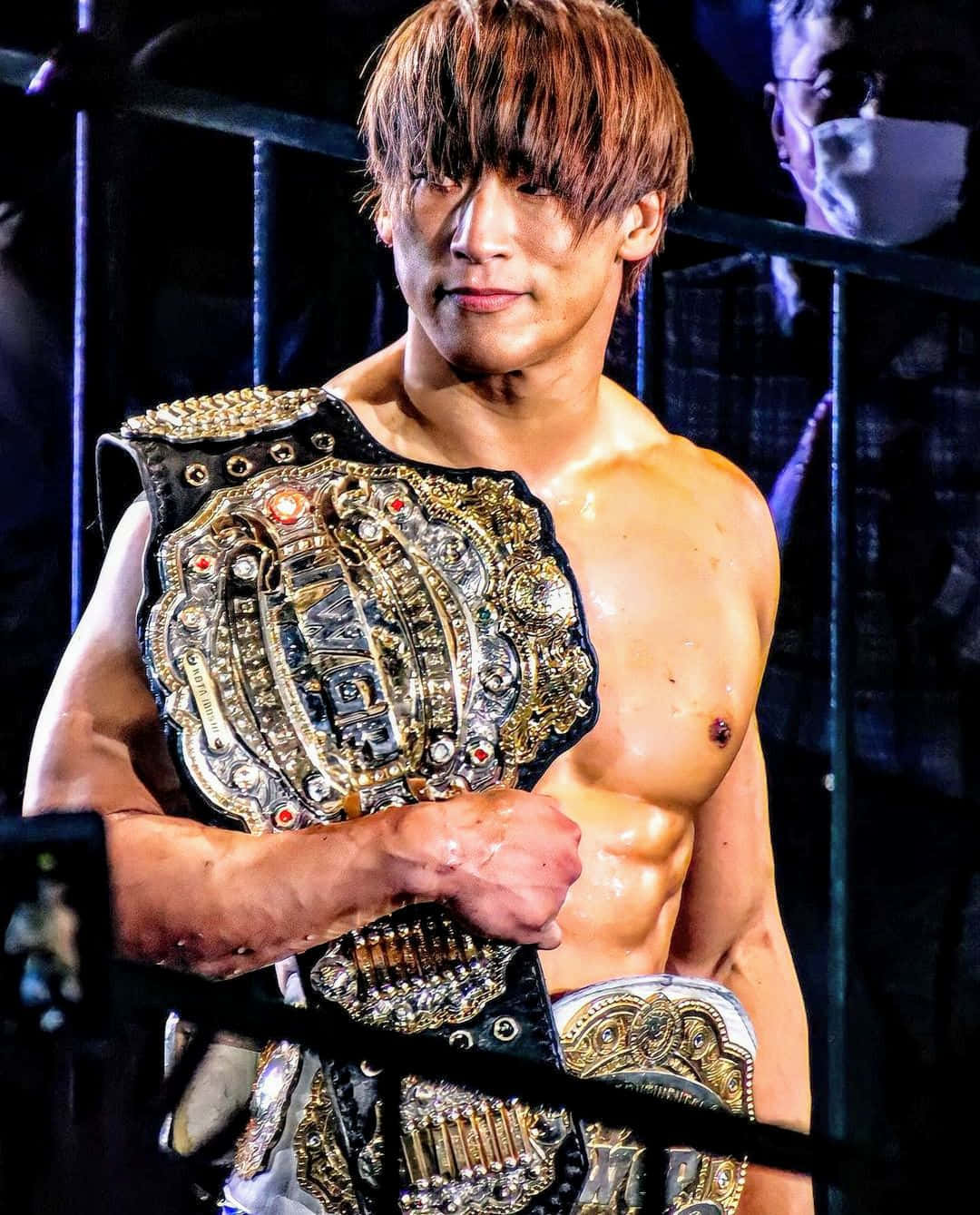 Caption: Kota Ibushi Holding Iwgp Intercontinental Champion Title Wallpaper