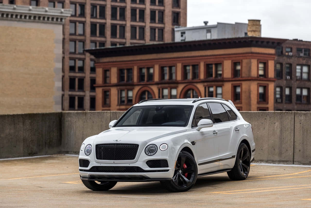 Caption: Majestic Bentley Bentayga On The Open Road Wallpaper