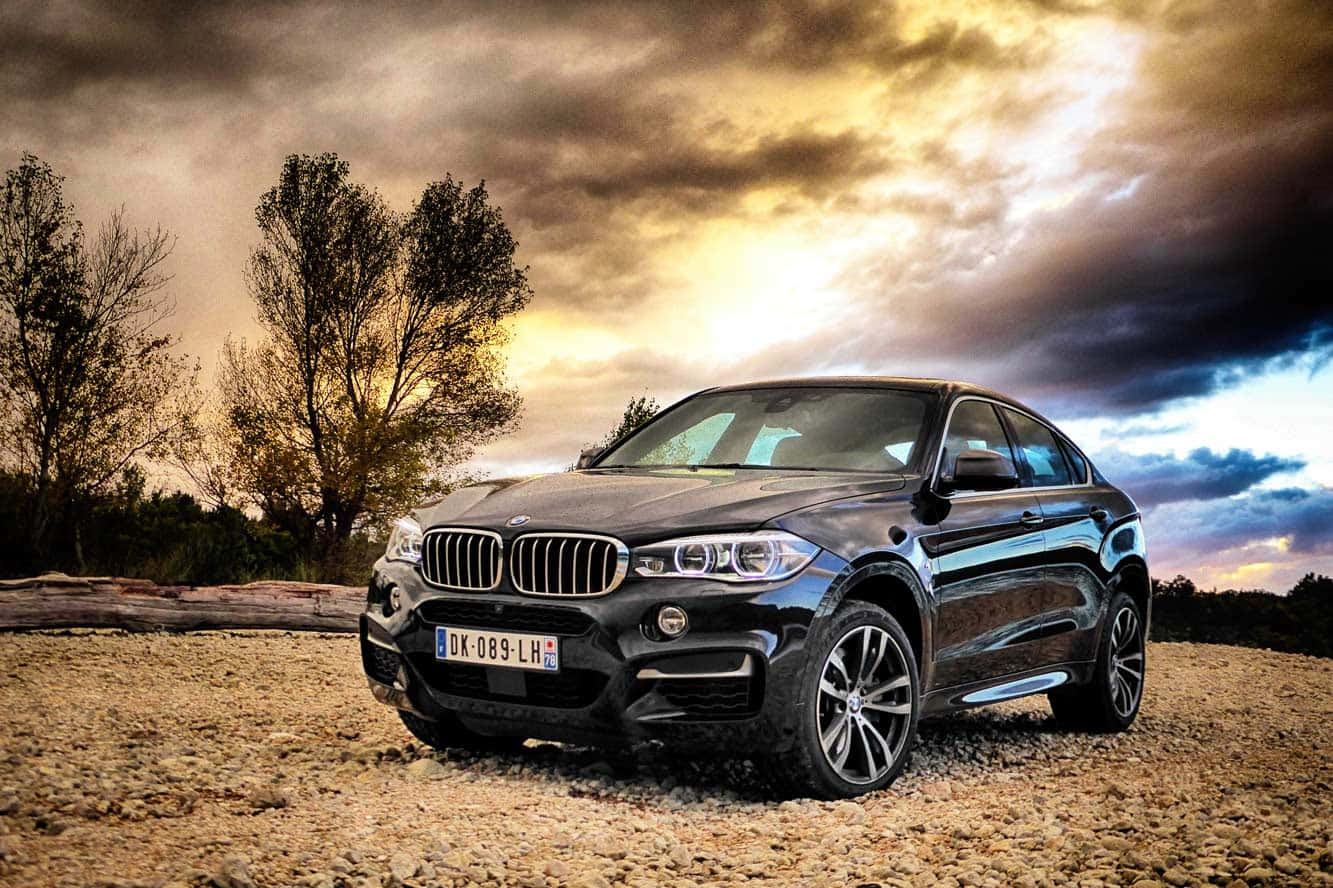 Caption: Majestic Bmw X6 In A Scenic Mountainous Landscape Wallpaper