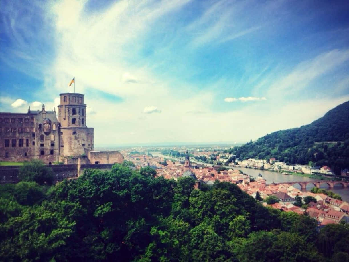 Caption: Majestic Heidelberg Castle Under Thin Clouds Wallpaper