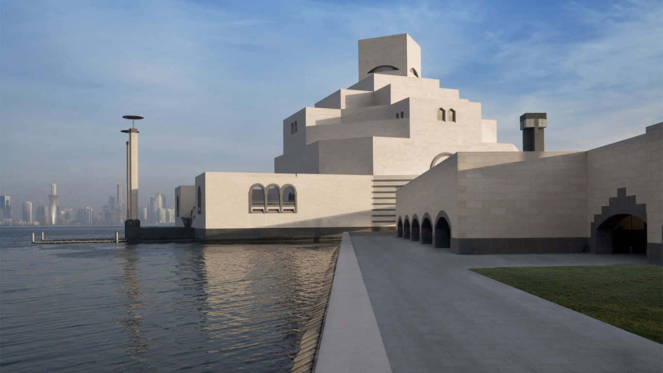 Caption: Majestic Museum Of Islamic Art Beneath A Clear Blue Sky Wallpaper