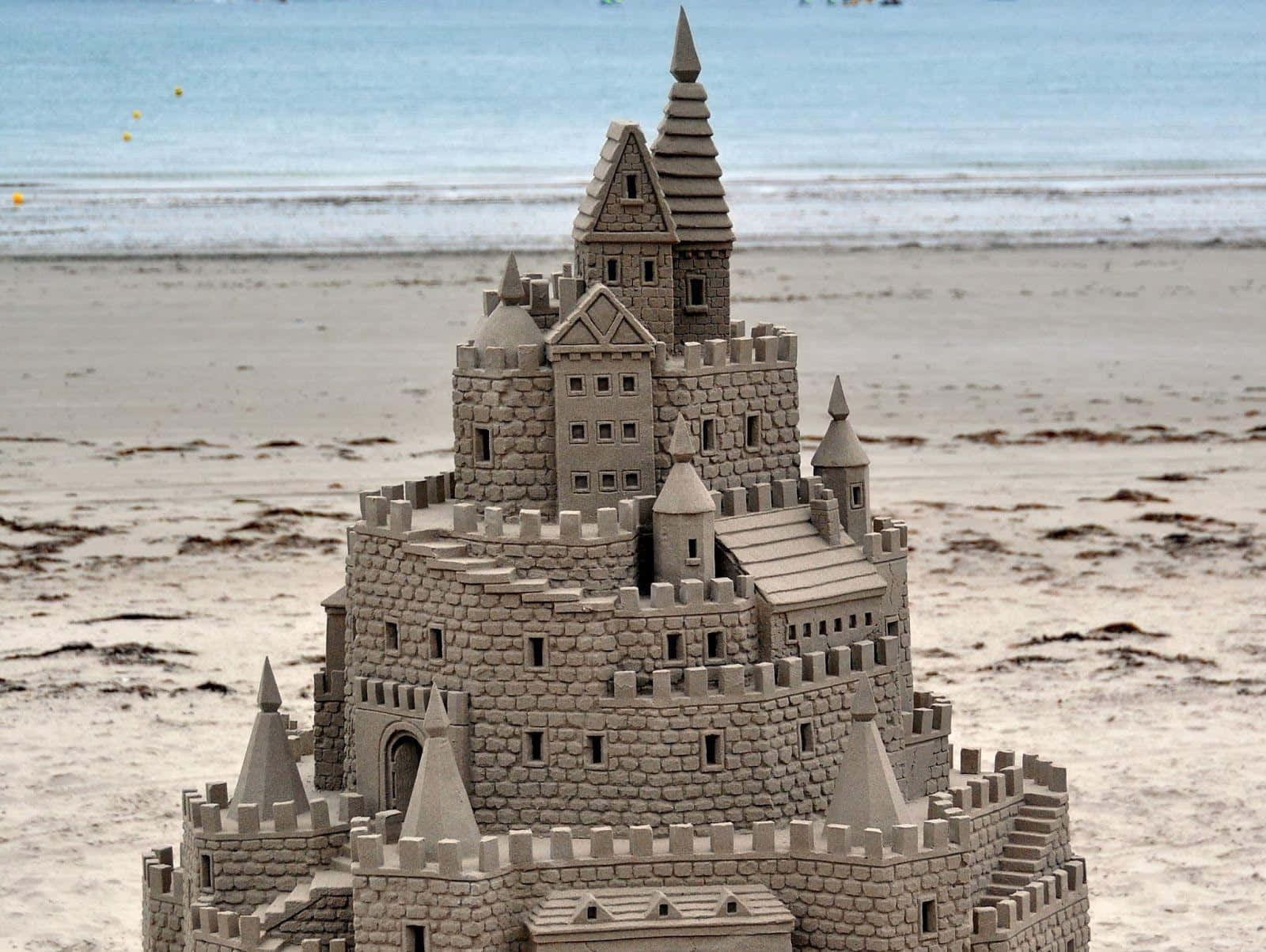 Caption: Majestic Sandcastles On A Sunny Beach Wallpaper