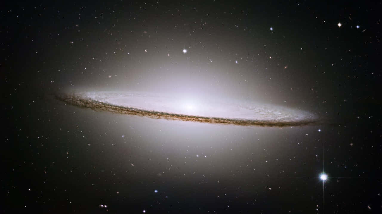 Caption: Majestic Sombrero Galaxy Swirling In Celestial Wonder Wallpaper