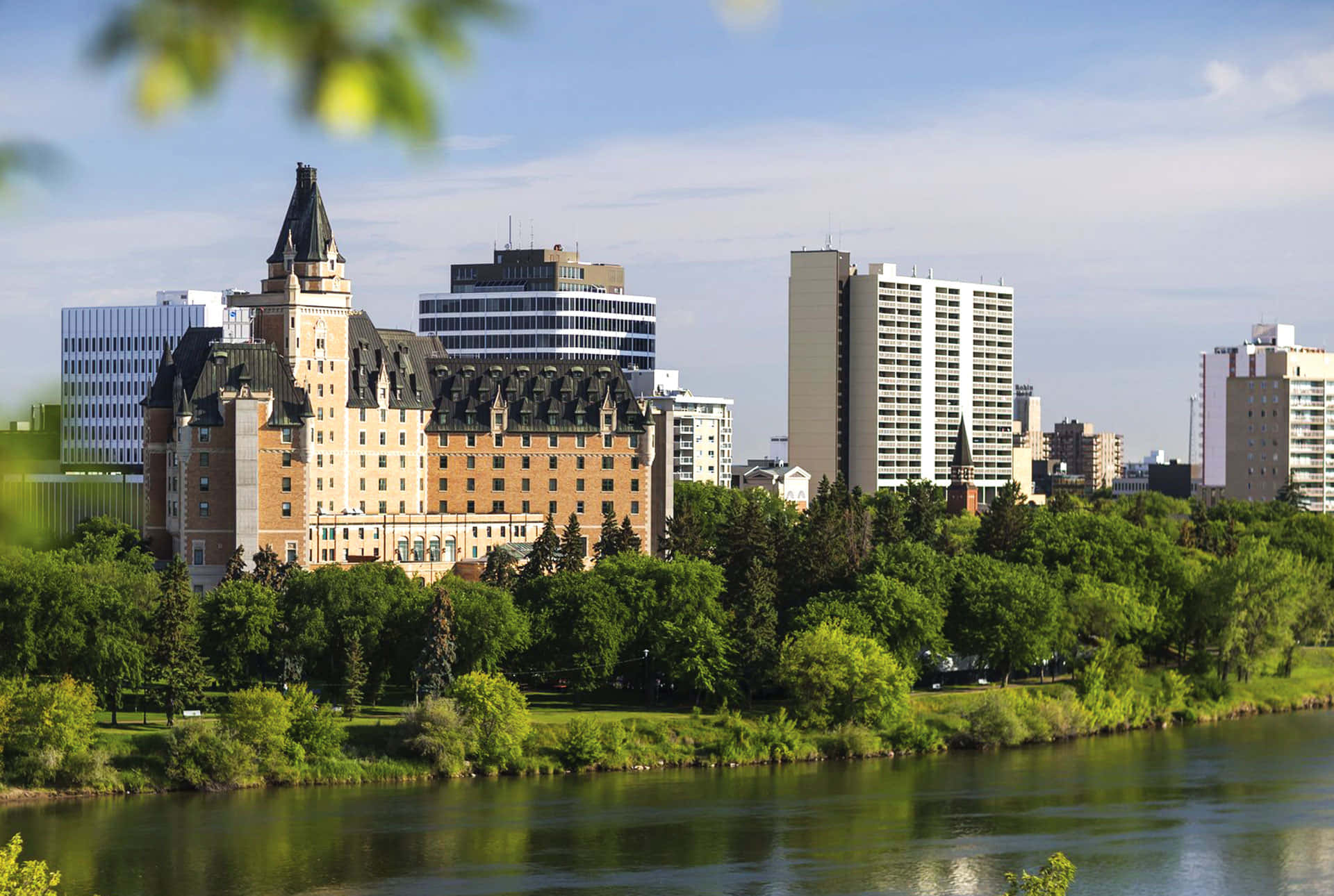 Caption: Majestic Sunset Over Saskatoon Skyline Wallpaper