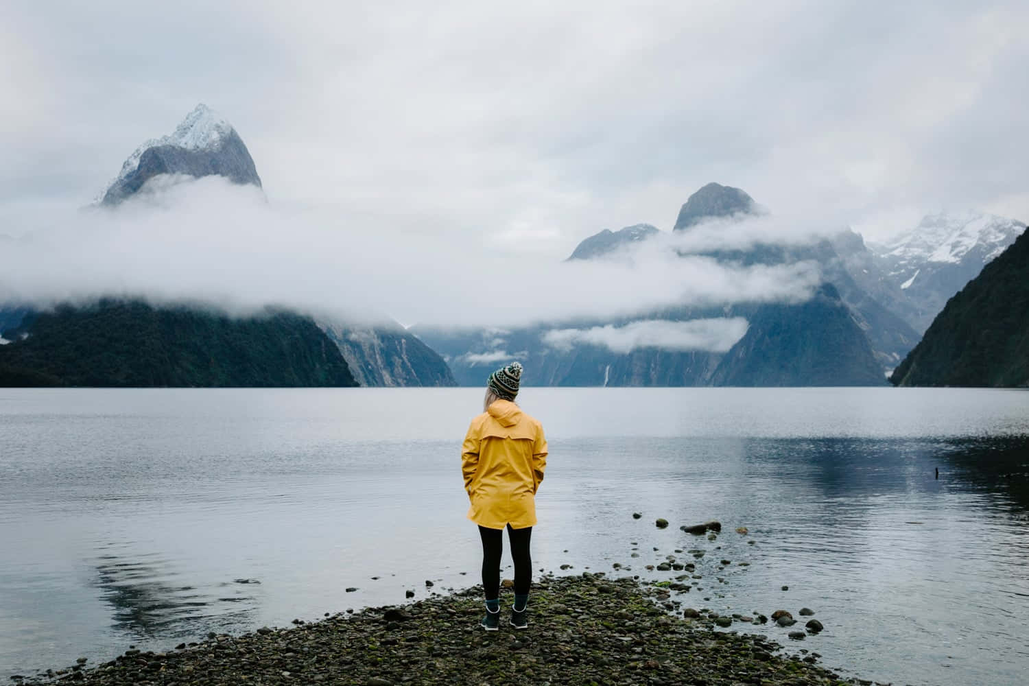 Caption: Majestic View Of Milford Sound And Its Rocky Landscape Wallpaper