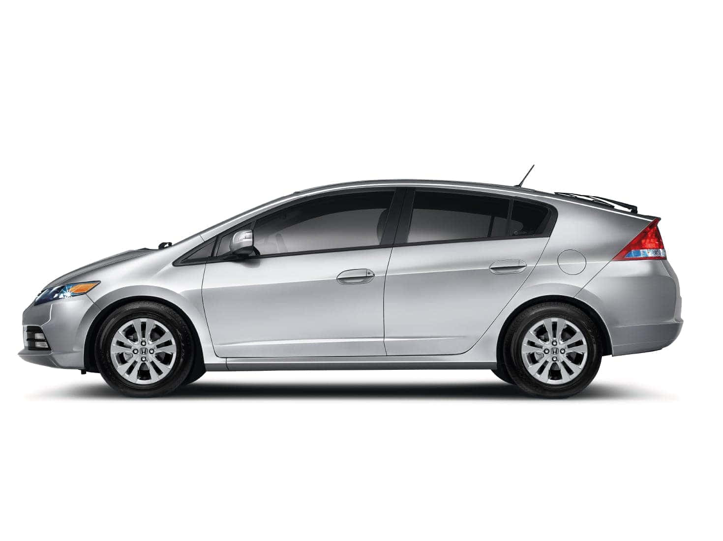 Caption: Modern Silver Honda Insight On Street Wallpaper