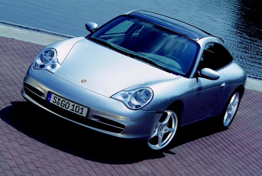 Caption: Porsche 996 Parked In Scenic Sunset Wallpaper