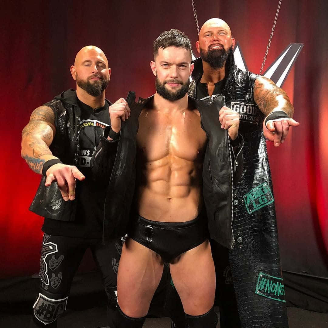 Caption: Professional Wrestler Karl Anderson Posing With Gallows Balor. Wallpaper