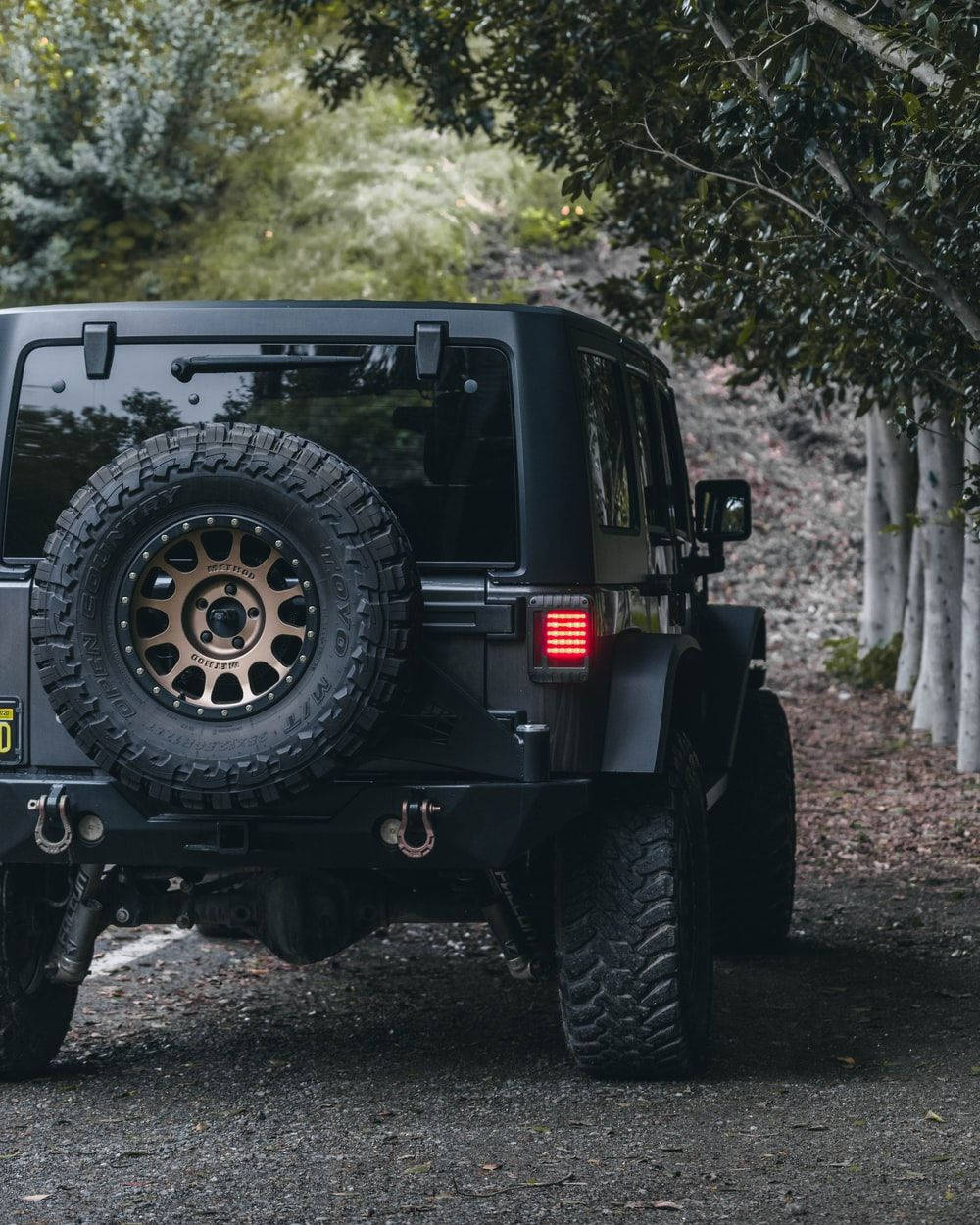 Caption: Rugged Black Jeep Wrangler Jk Dominating The Terrain Wallpaper