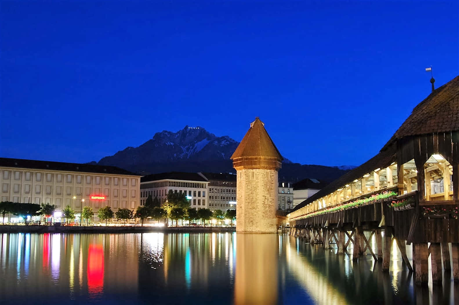 Caption: Serene Lucerne Lake With Majestic Snow-capped Mountains Wallpaper