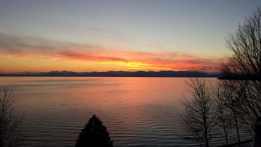 Caption: Serene Sunrise Over Lake Champlain, Burlington Wallpaper