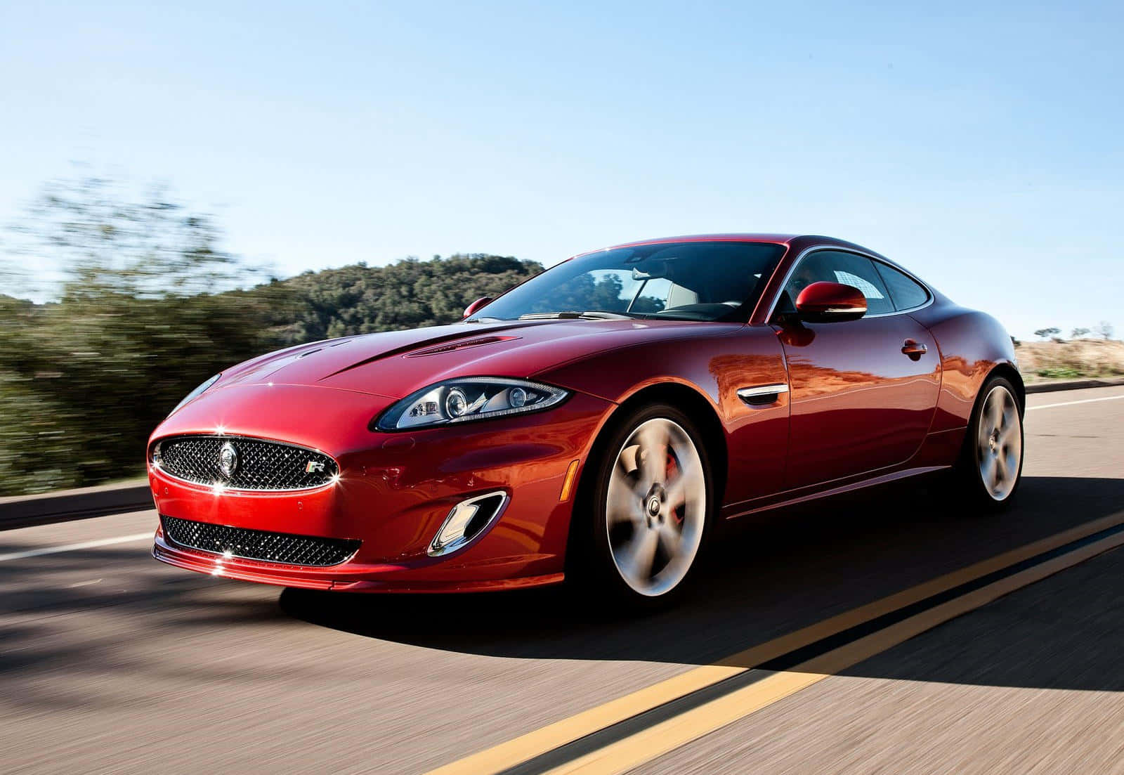 Caption: Sleek And Elegant Jaguar Xkr In Action Wallpaper