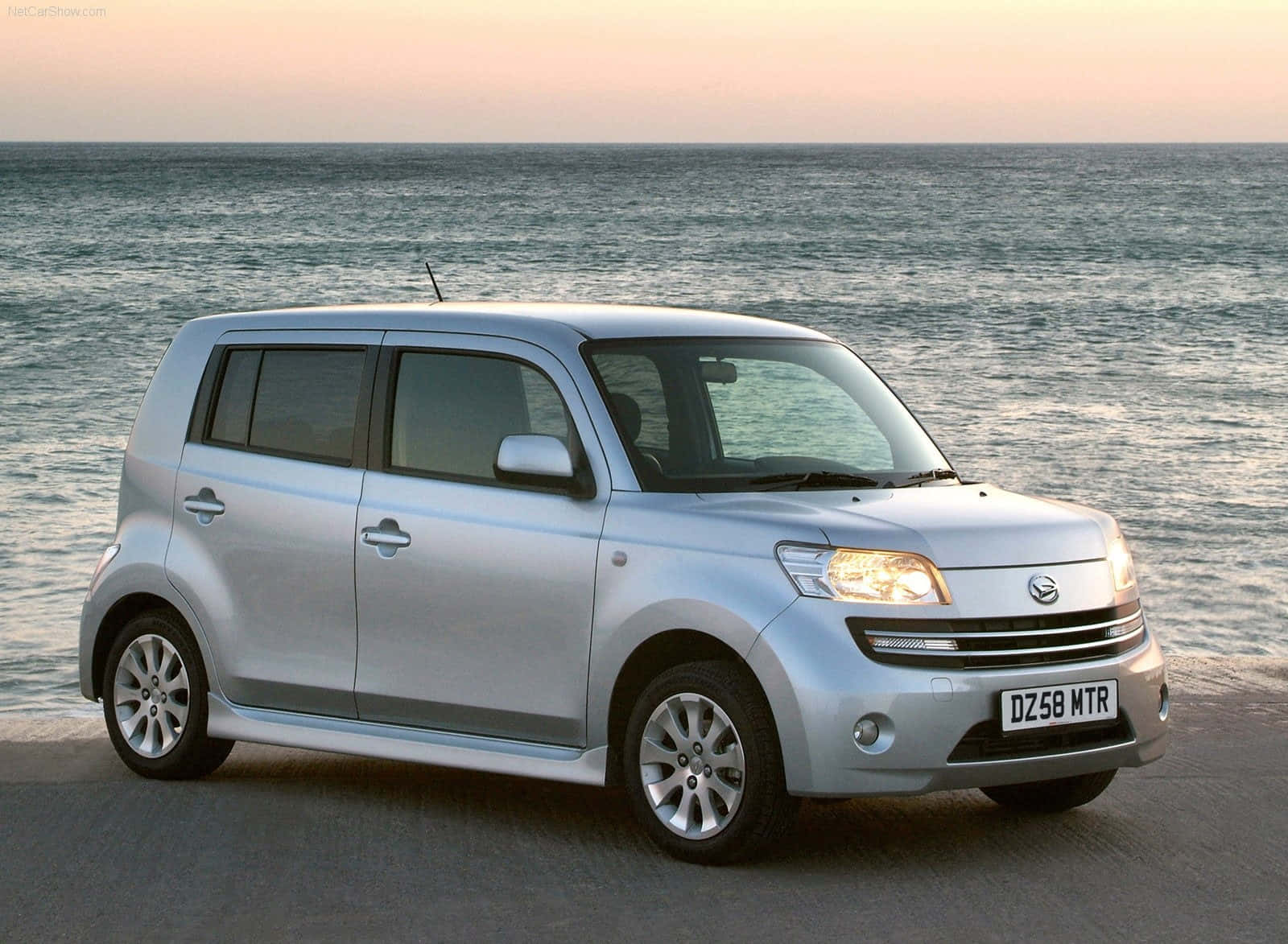 Caption: Sleek And Stylish Daihatsu On The Road Wallpaper