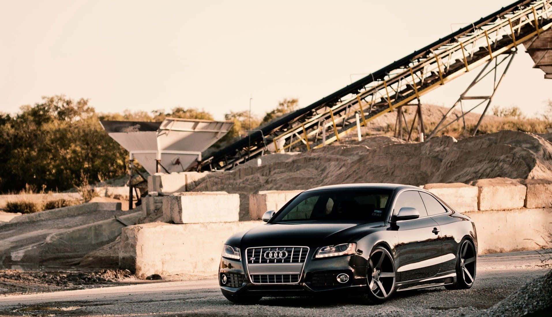 Caption: Sleek Audi S6 Sport Sedan On Urban Road Wallpaper