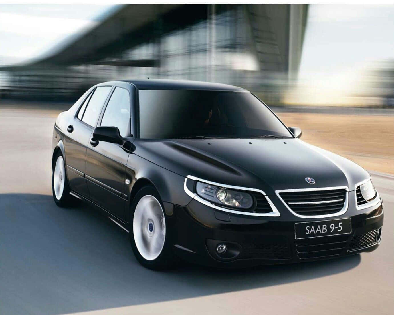 Caption: Sleek Saab 9-5 Car In An Outdoor Setting Wallpaper