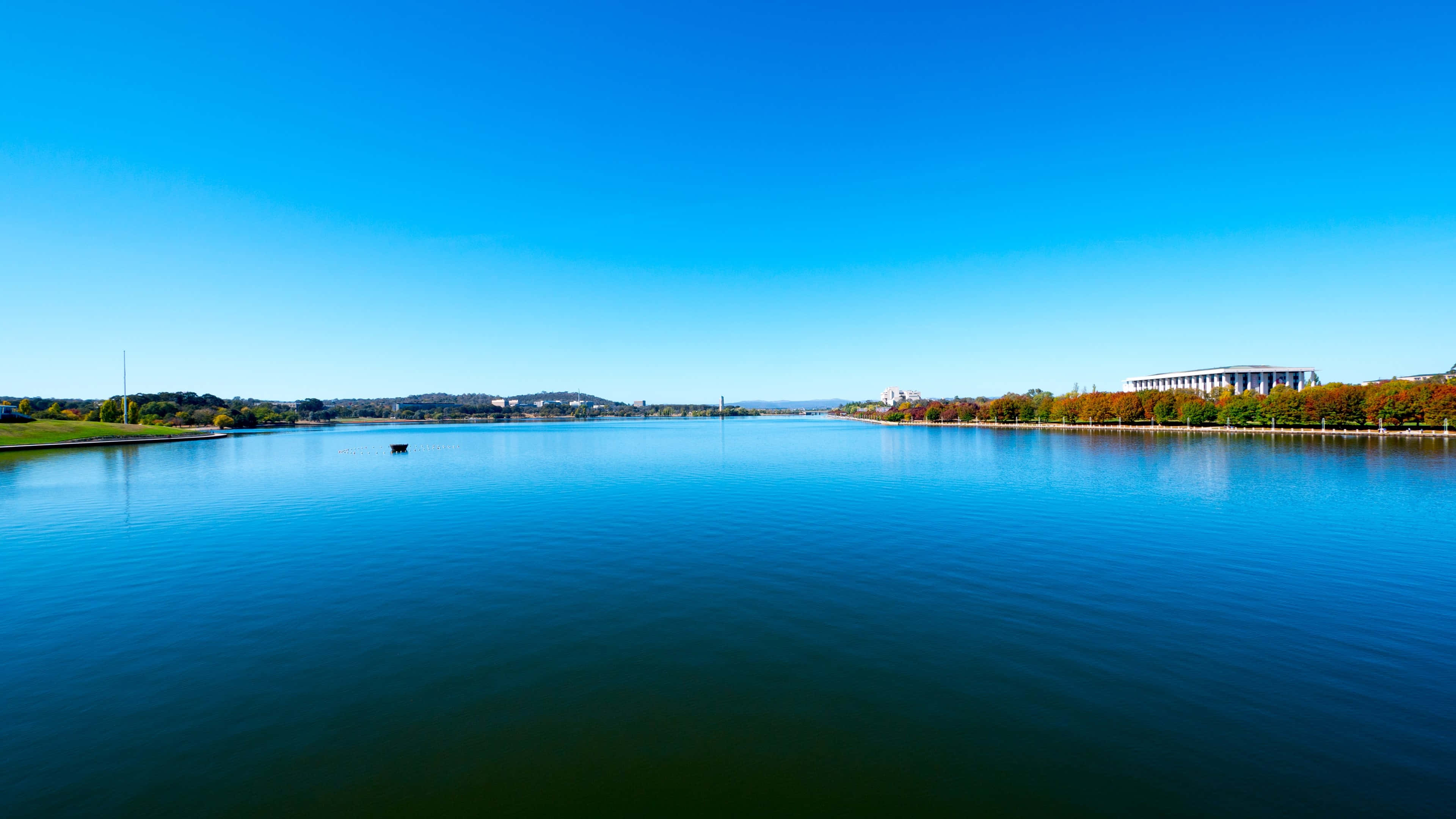 Caption: Stunning 4k View Of Serene River Landscape Wallpaper