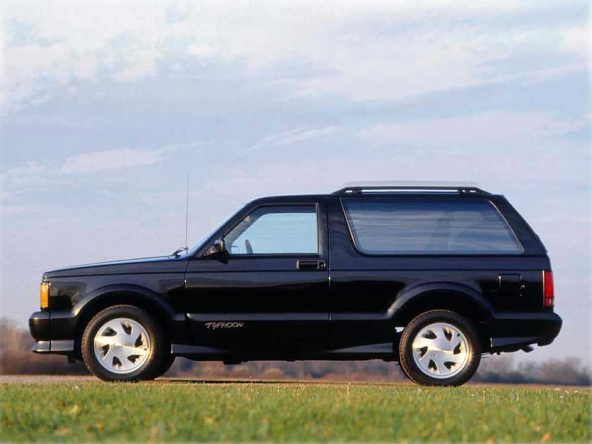 Caption: Stunning Red Gmc Typhoon In Its Element Wallpaper