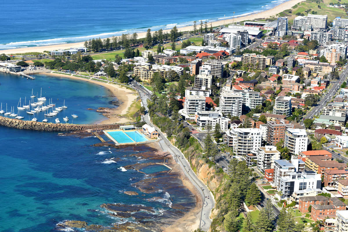 Caption: Stunning Sunrise Over Wollongong Coastline Wallpaper