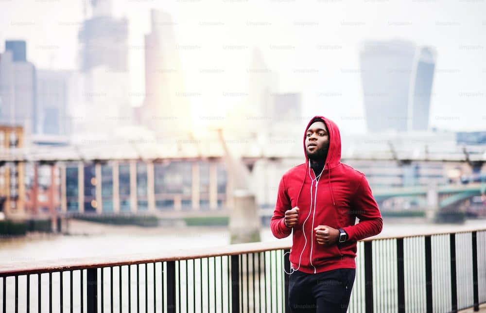 Caption: Stylish Person In A Vibrant Red Hoodie Wallpaper