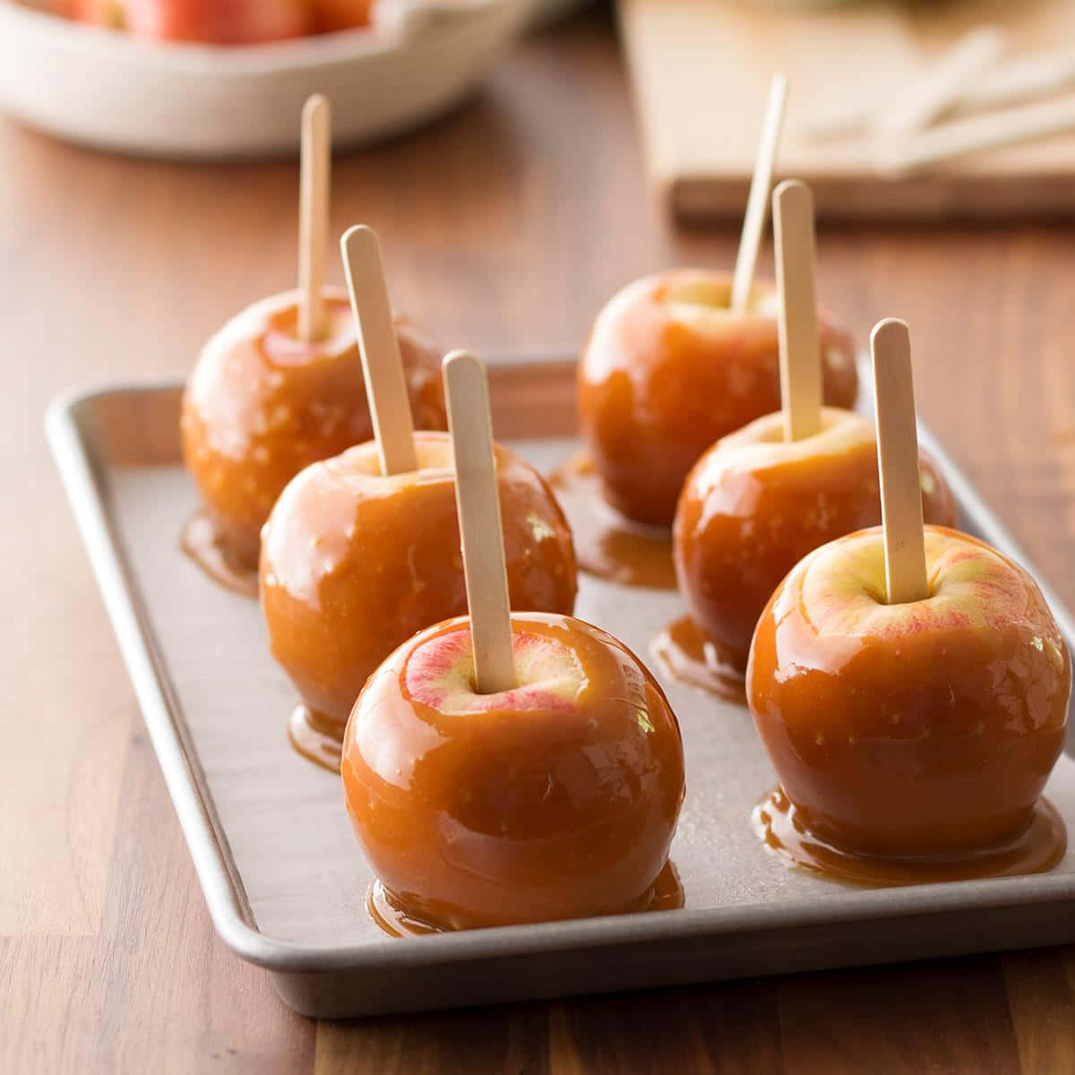 Caption: Succulent Caramel Apples Ready To Savour Wallpaper