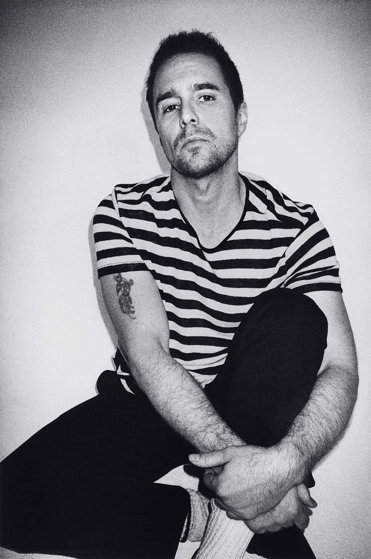 Caption: The Enigmatic Sam Rockwell In Black And White Wallpaper