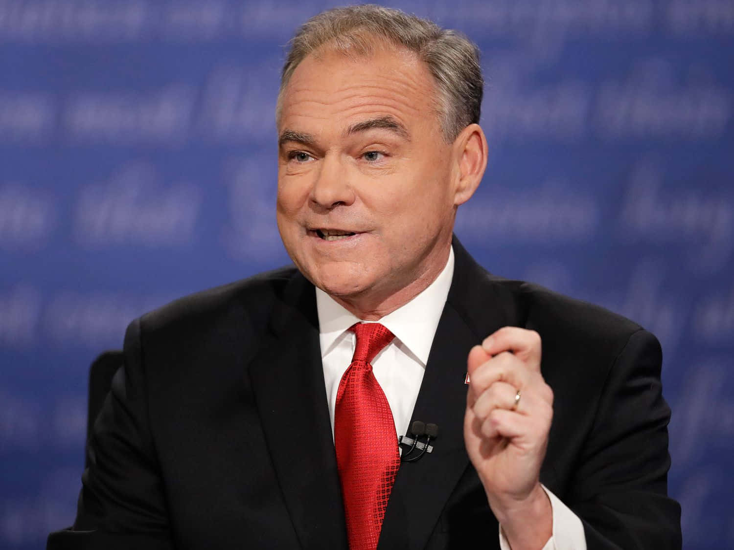 Caption: Tim Kaine Posing Against A Dark Blue Background Wallpaper