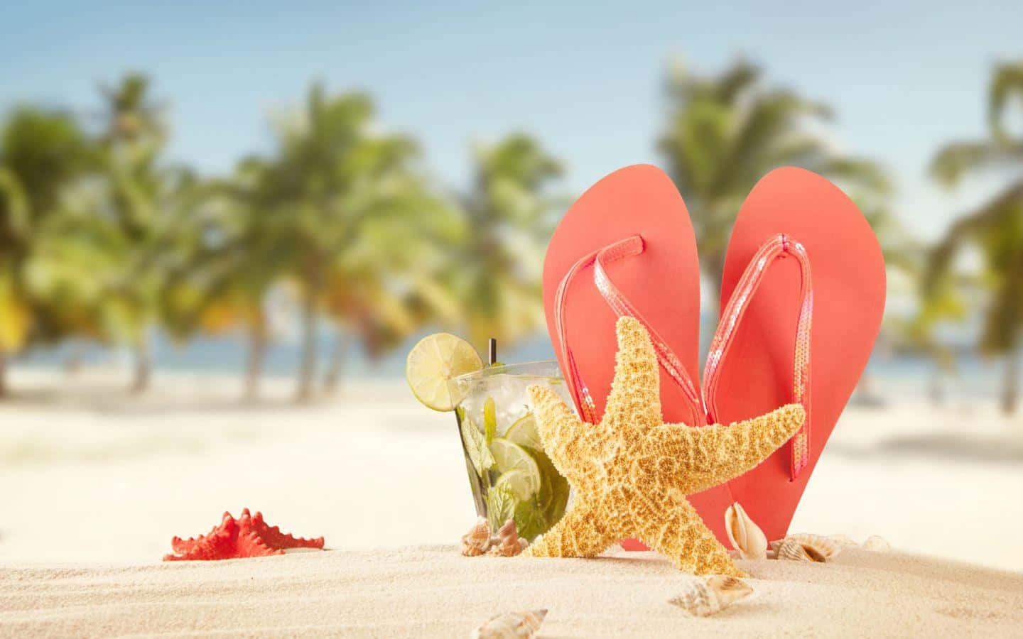 Caption: Vibrant Beach Sandals On Sandy Shore Wallpaper