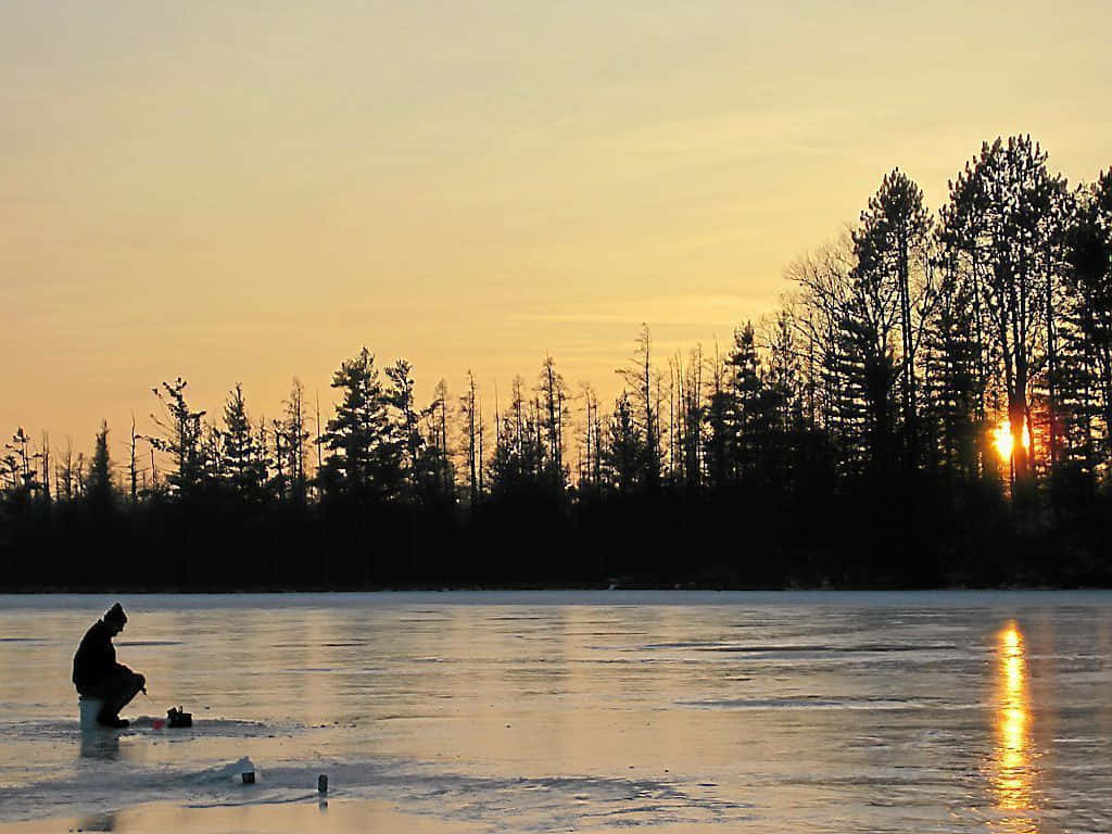 Caption: Winter Adventure - Ice Fishing On A Frozen Lake Wallpaper