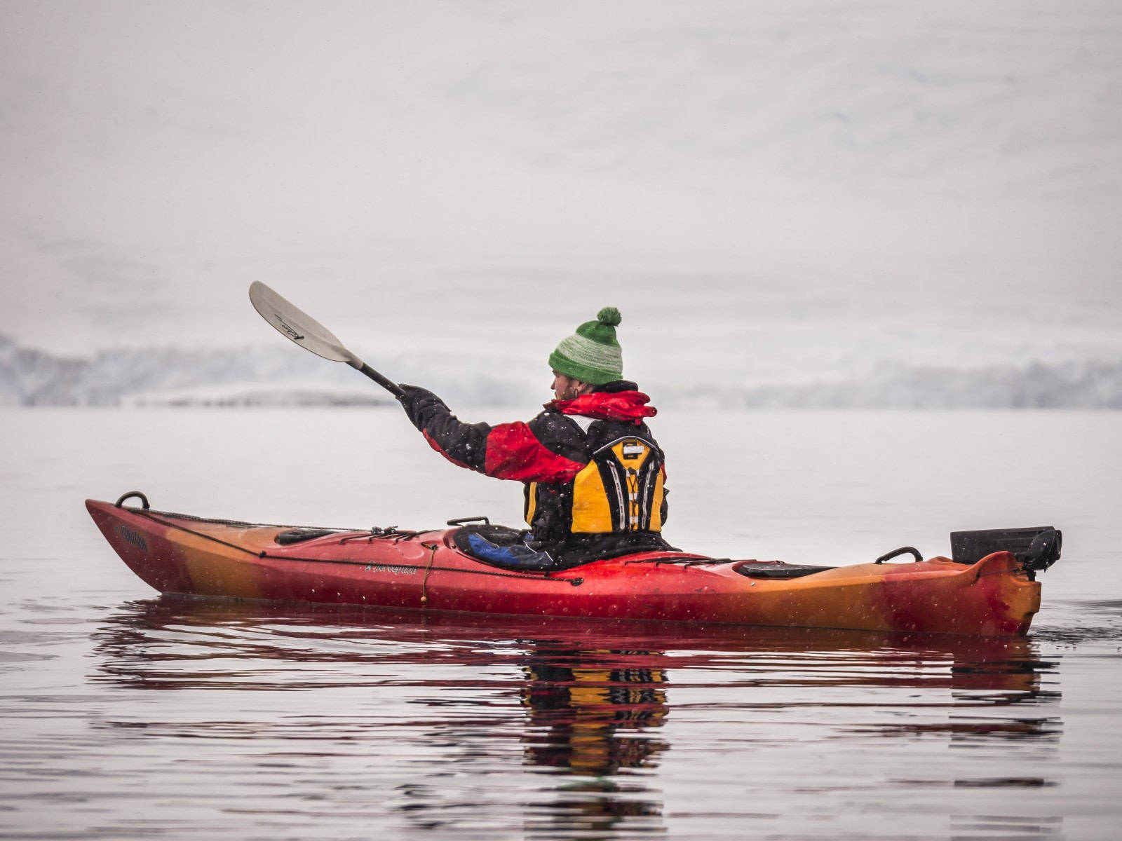 Caption: Winter Wonderland Kayaking Adventure Wallpaper