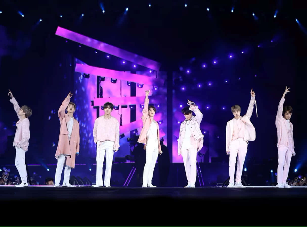 Captivating Moment Of Bts Performing On Stage Wallpaper