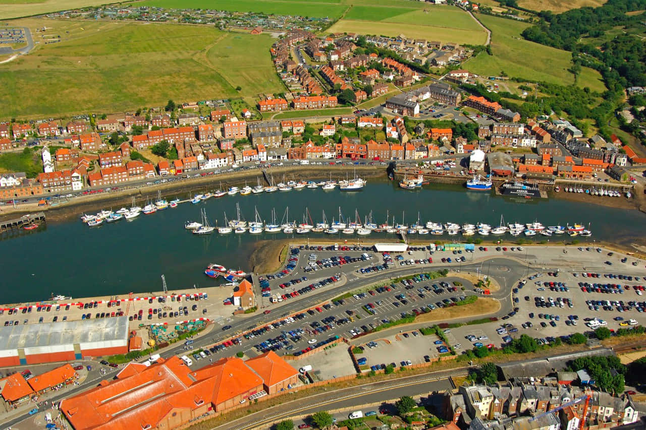 Captivating Sunset Over Whitby Harbor Wallpaper