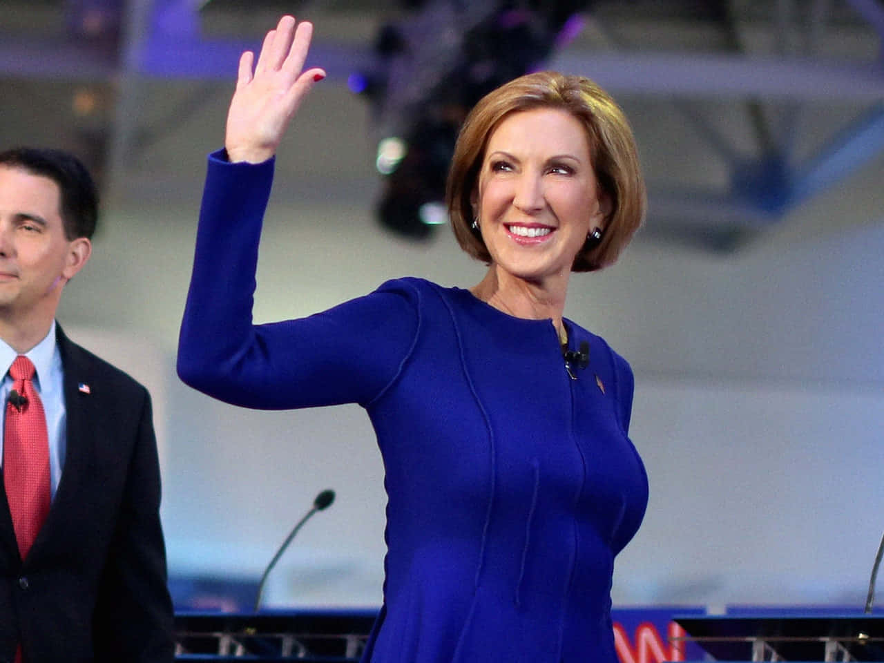 Carly Fiorina Waving In Blue Dress Wallpaper