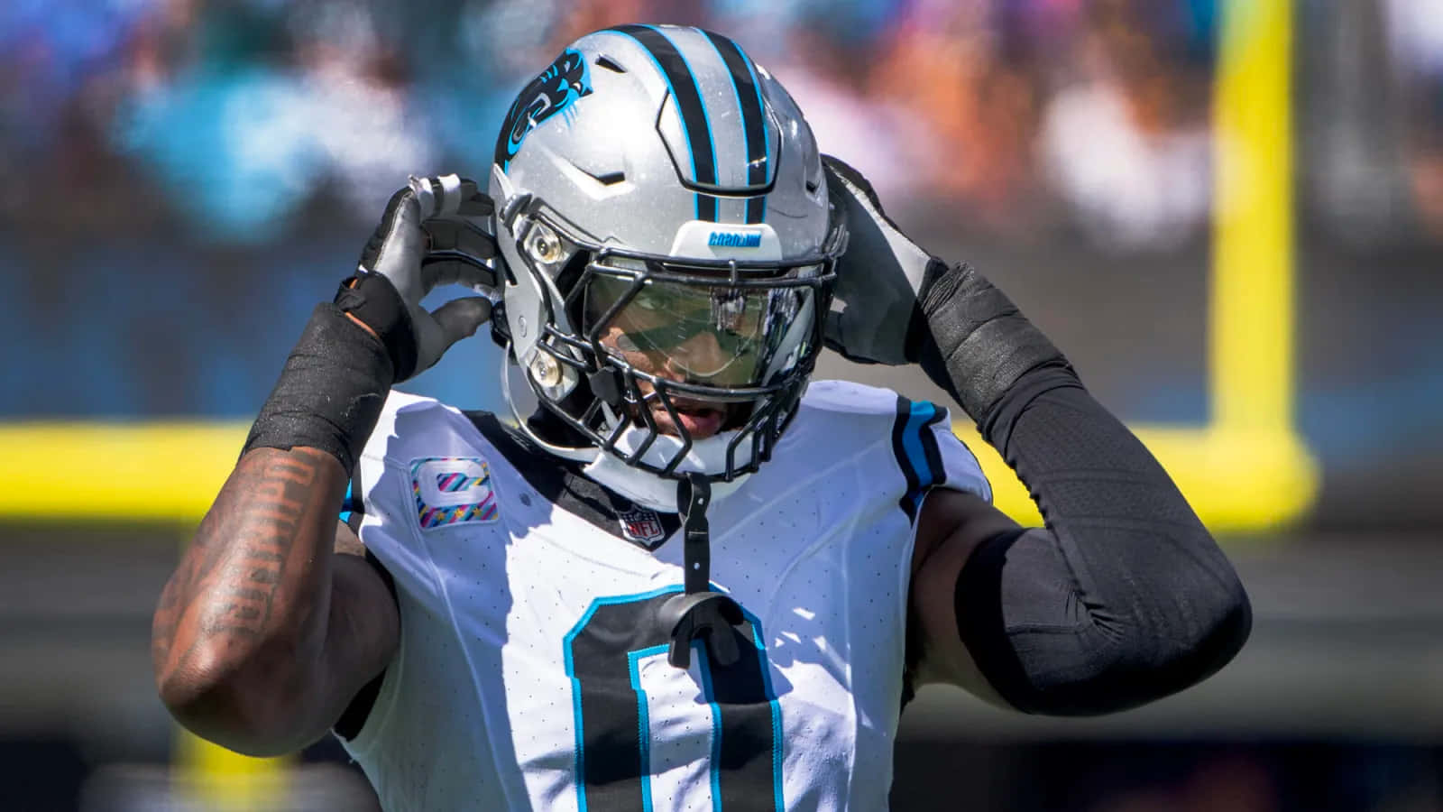 Carolina Panthers Player Adjusting Helmet Wallpaper