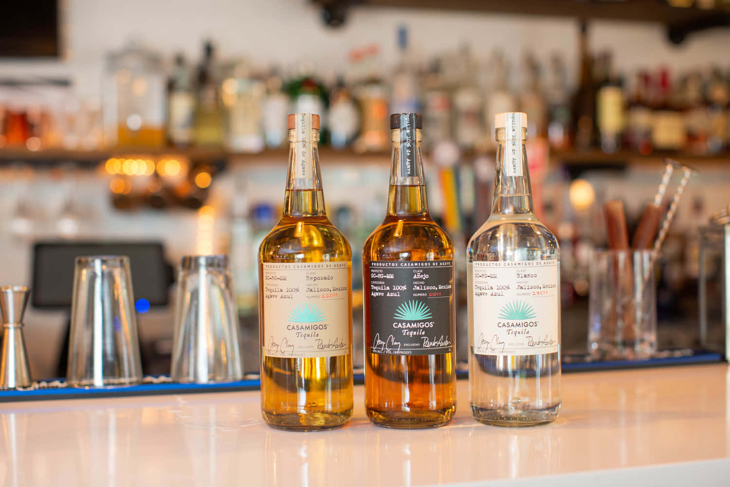 Casamigos Tequila Liquor Bottles On Bar Counter Wallpaper