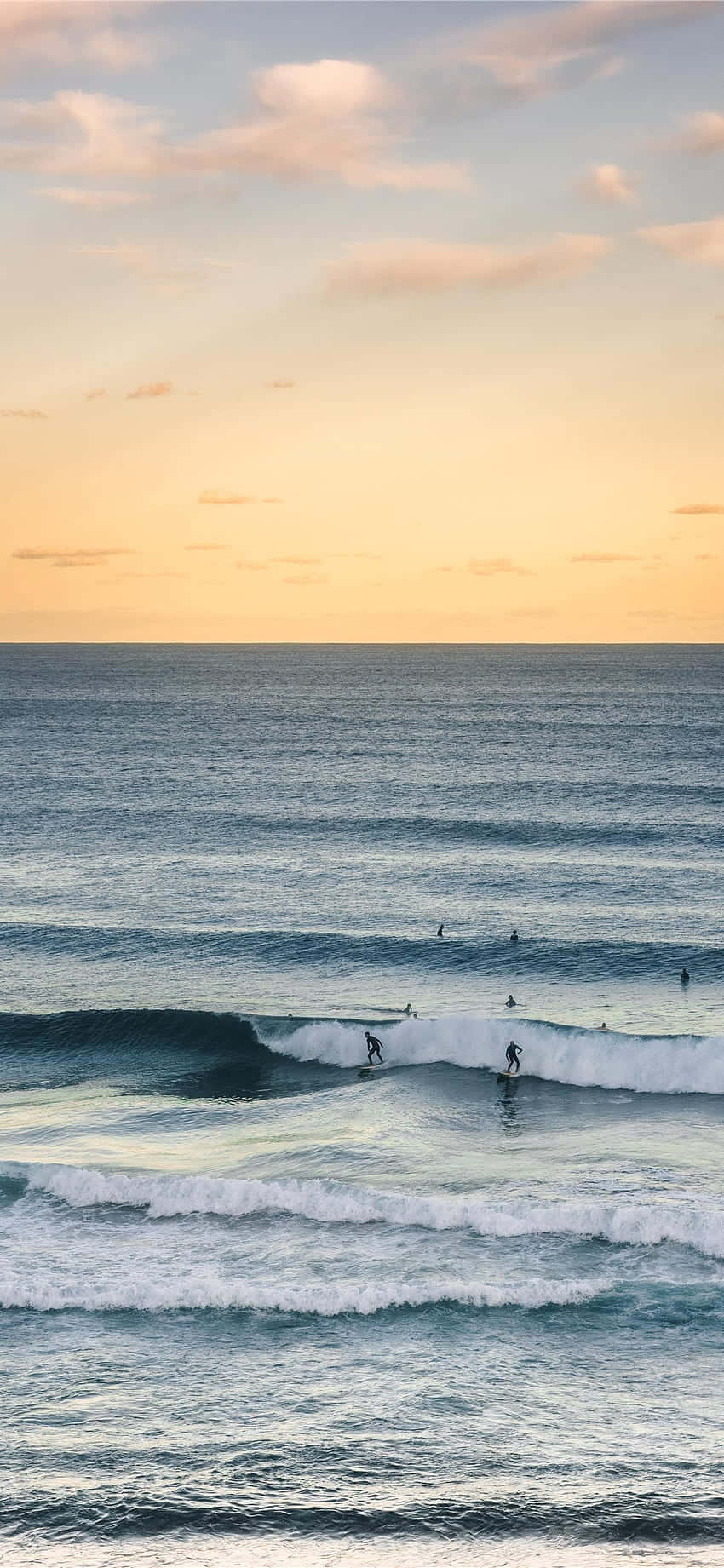 Catch The Wave - A Surfer Riding A Wave In The Ocean While Using Their Iphone Wallpaper