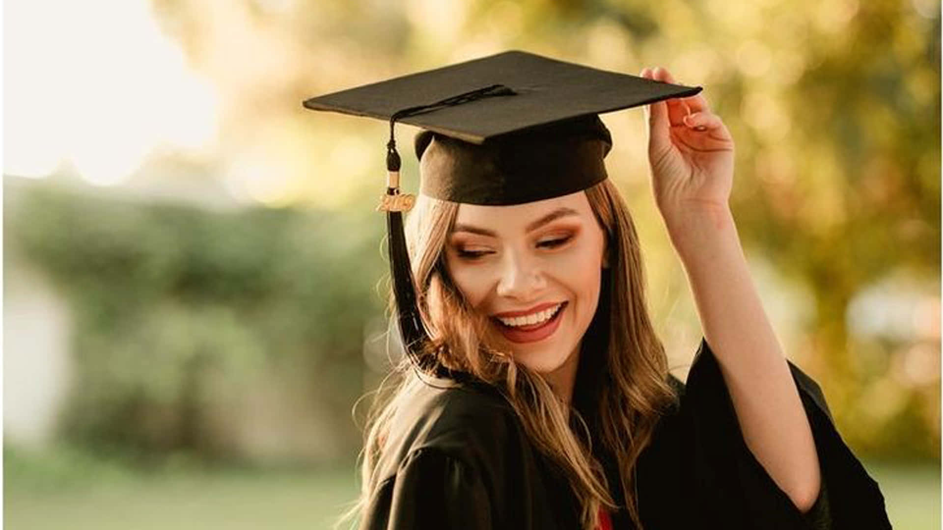 Celebrating One's Educational Achievements At A Graduation Ceremony. Wallpaper