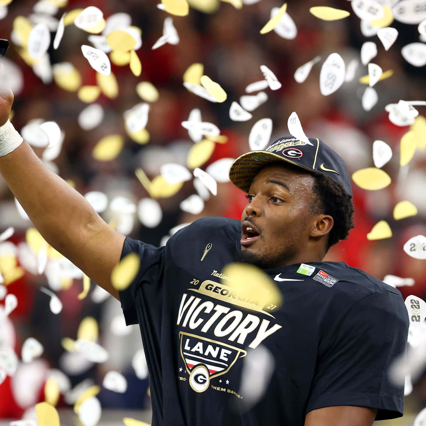 Celebratory_ Athlete_ Amidst_ Confetti Wallpaper