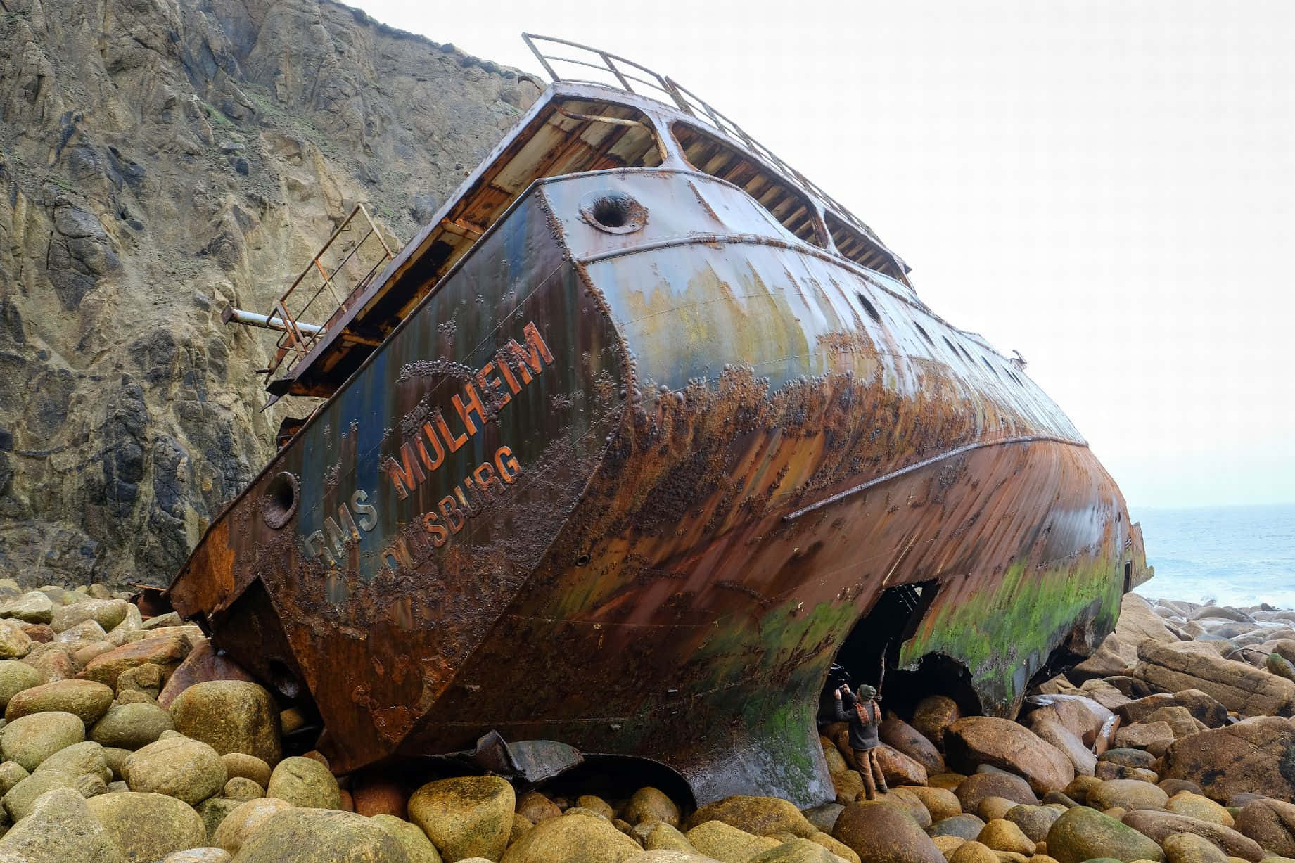 Century-old Shipwreck Against The Backdrop Of A Spectacular Sunset Wallpaper