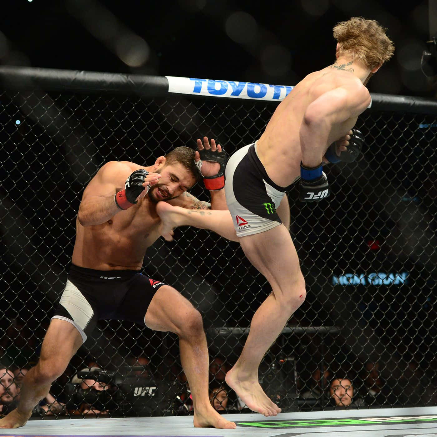 Chad Mendes Receiving A Kick Wallpaper