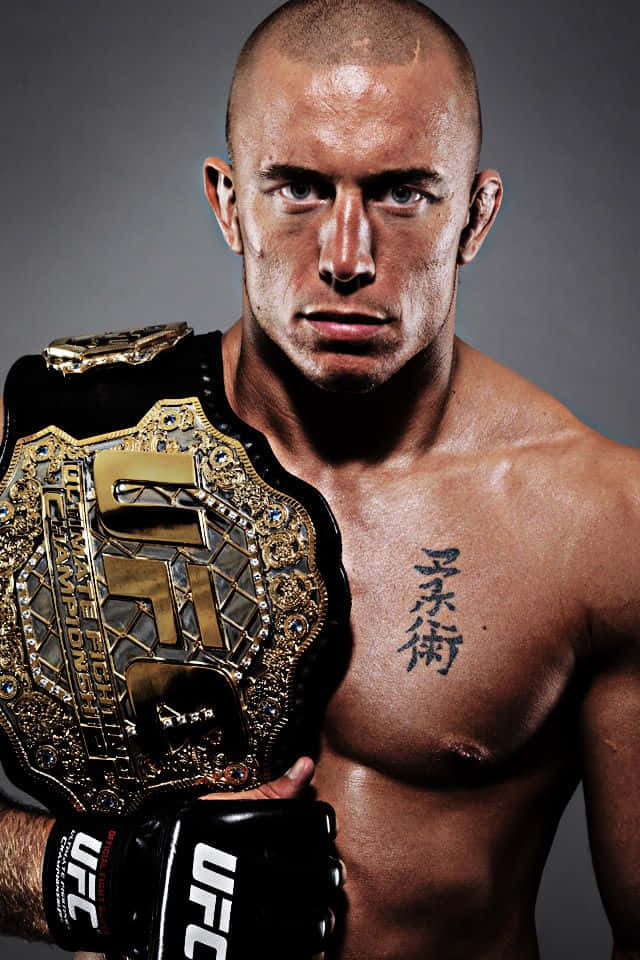 Champion Georges St-pierre, Reigning Ufc Title Holder With His Belt Wallpaper