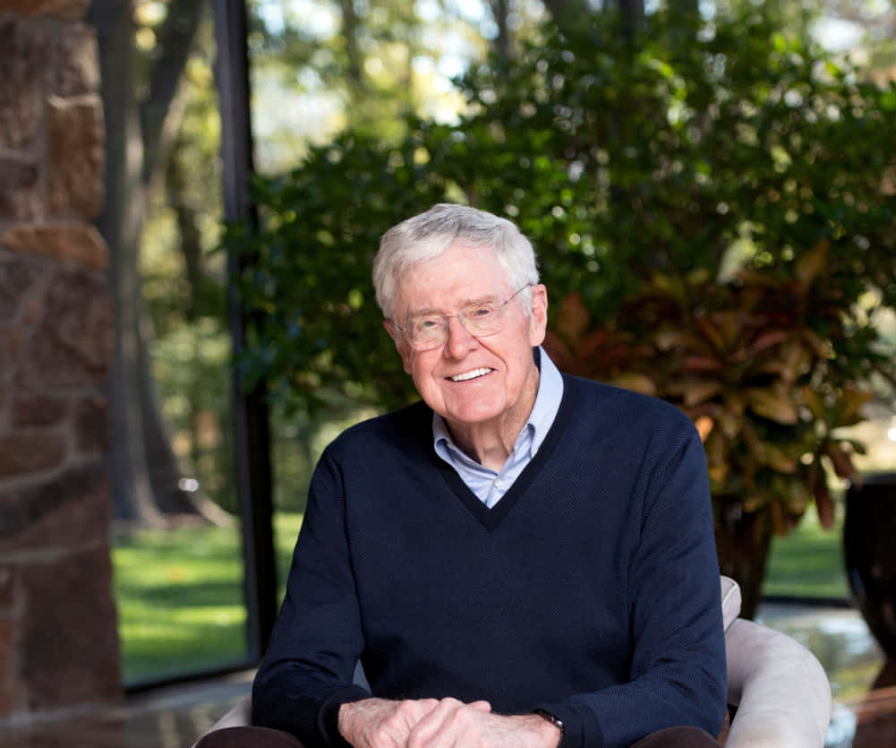 Charles G. Koch Sitting Near Trees Wallpaper