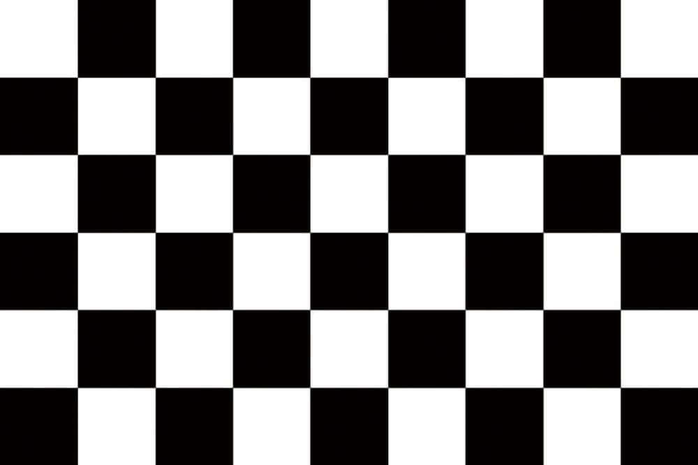 Chequered Flag Waving At A Motorsports Finish Line Wallpaper