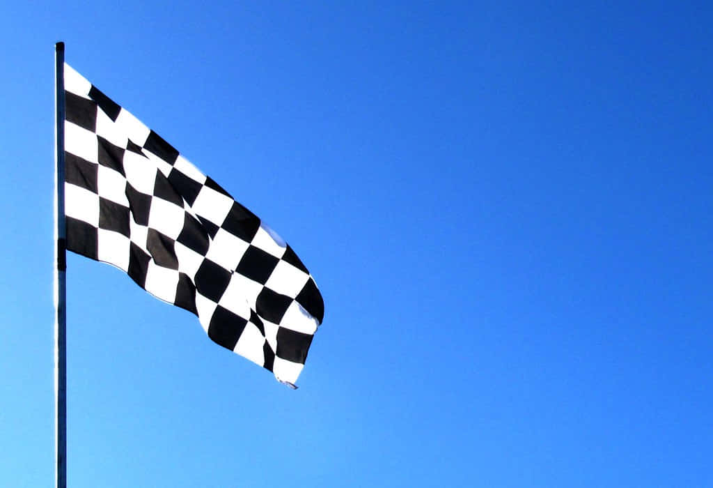 Chequered Flag Waving At The Finish Line Wallpaper